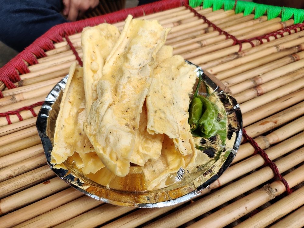 Plate of fafda paired with fried salted chilies